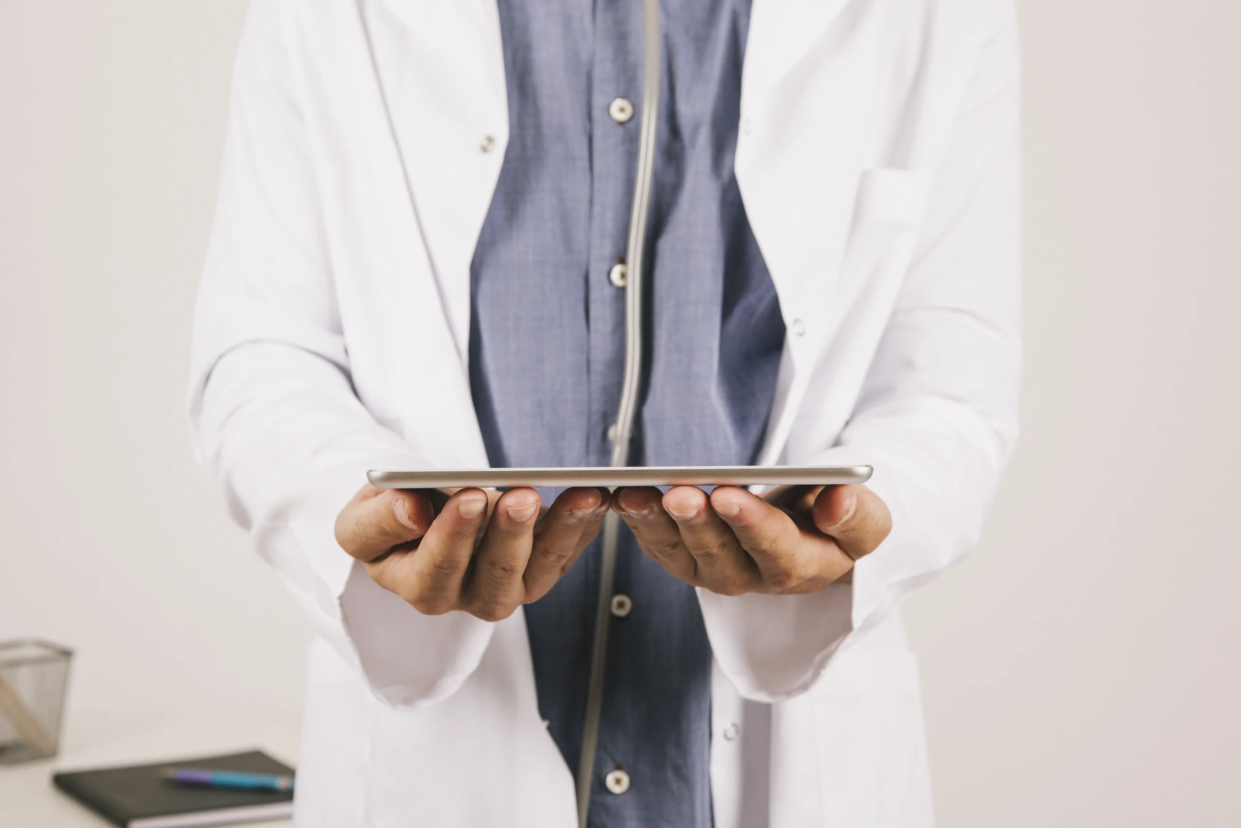 Doctor's hand holding a tablet.