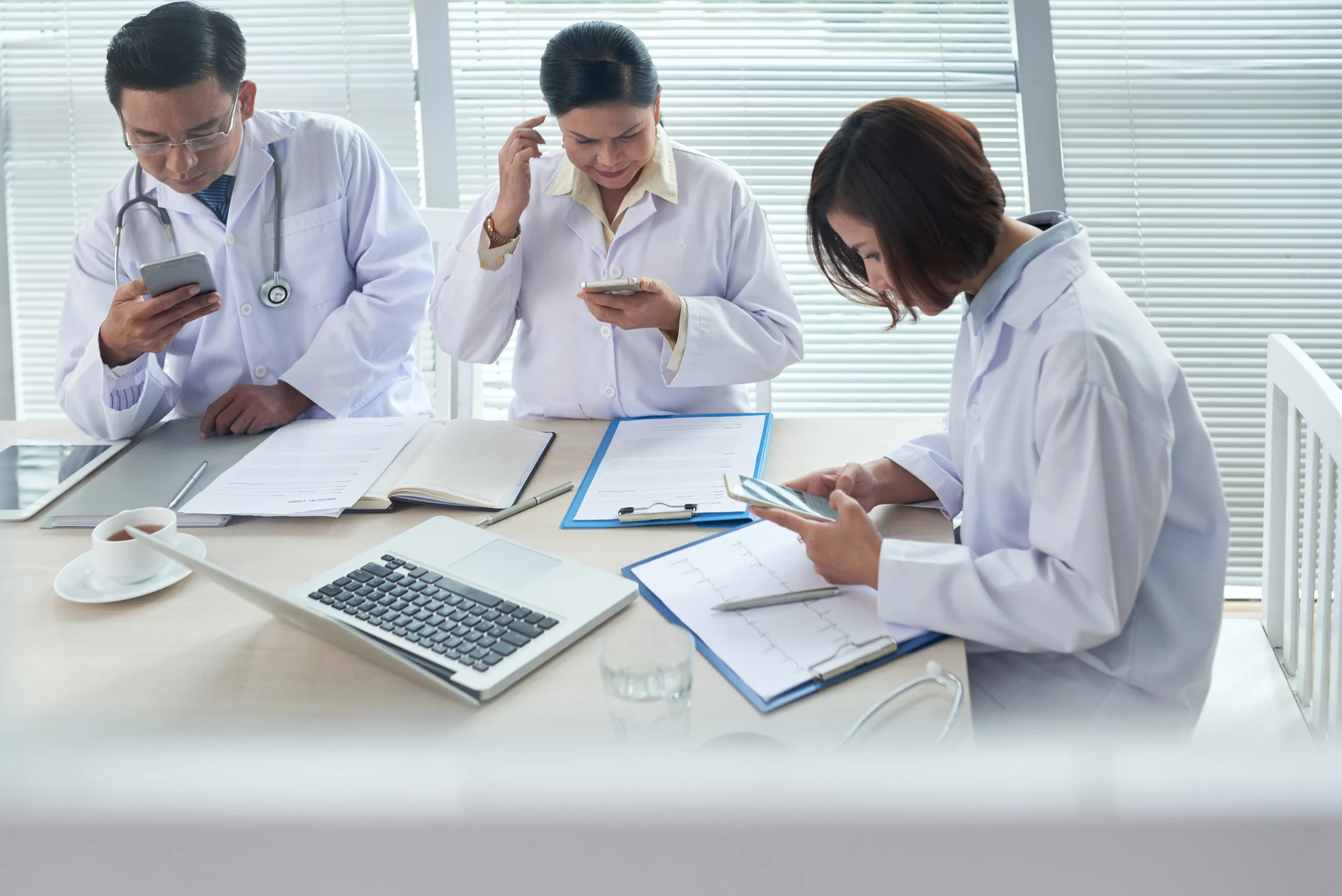 The three doctors looked dizzy as they looked at their phones.