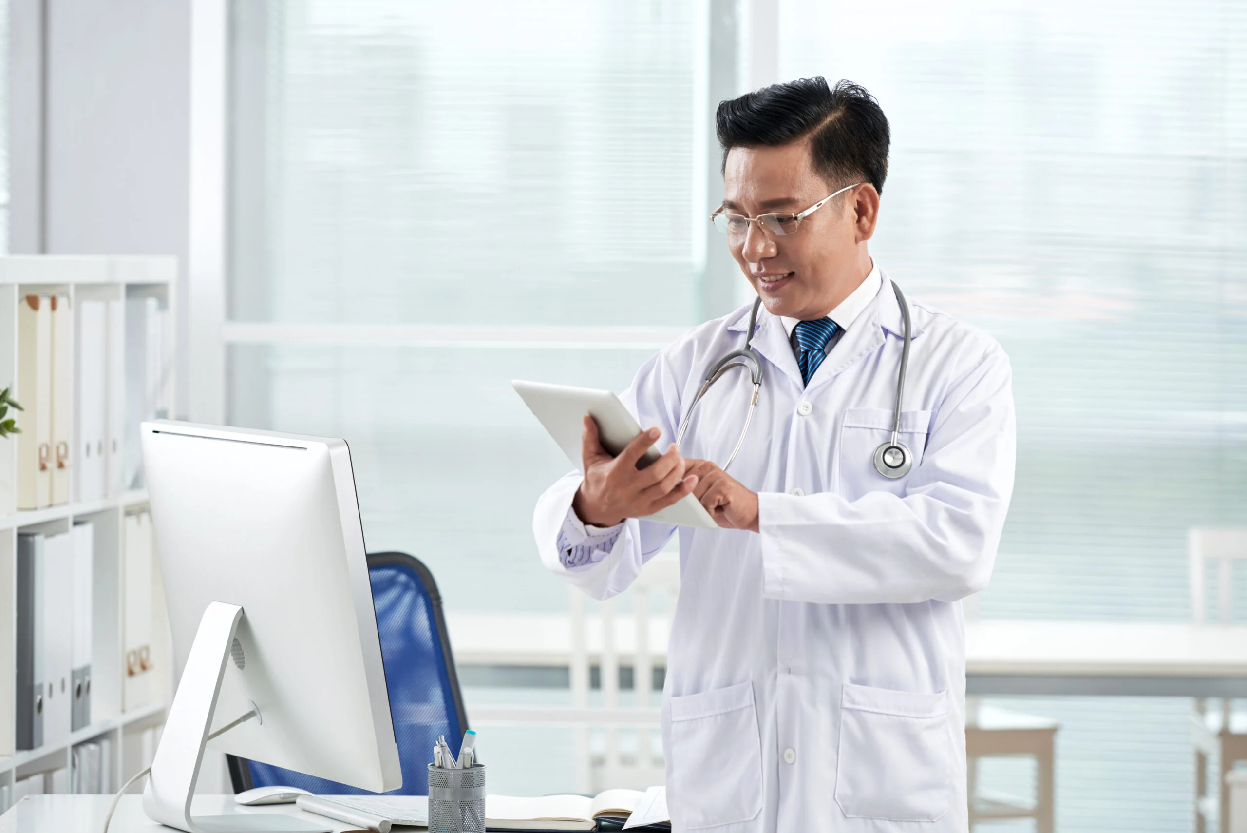 A doctor using a medical application on his digital device